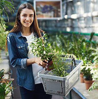 Young woman with plant in basket